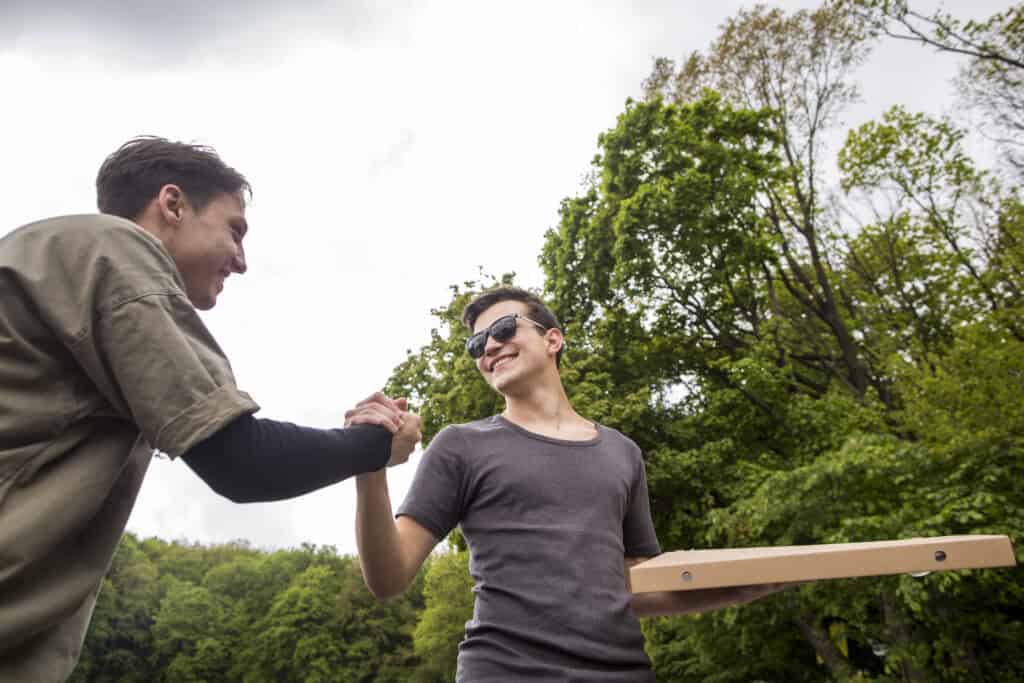 Happy man smiling outdoors, symbolizing recovery and a fresh start after completing treatment at a Drug Rehab in Orange County