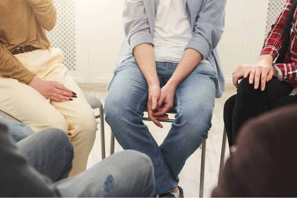 Group therapy session showing people seated in a supportive circle, symbolizing community-focused recovery at a Drug Rehab in Orange County.