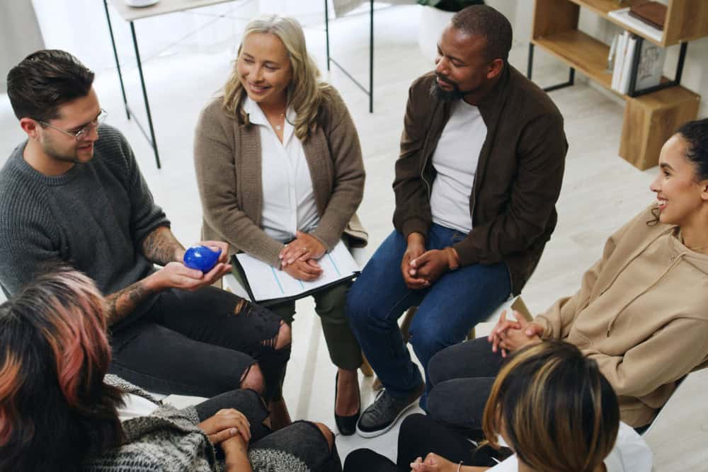 Clients participating in a supportive group meeting during Dual Diagnosis Treatment in Orange County.